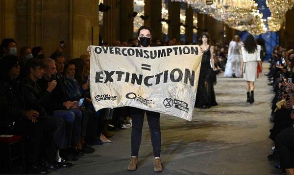 Activists interrupt the Louis Vuitton parade in Paris