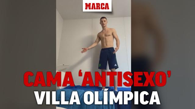 An athlete tests the 'antisexo' bed of the Olympic village