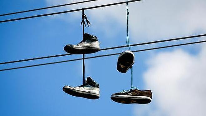 Secret codes behind shoes hanging on power lines