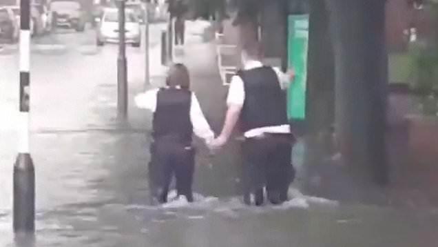 Families stranded and stations underwater as flash floods batter London 