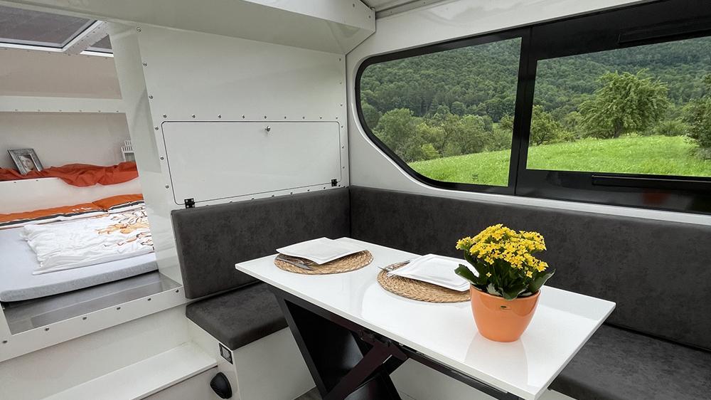 Expandable teardrop camper stretches into panoramic multi-room cabin 