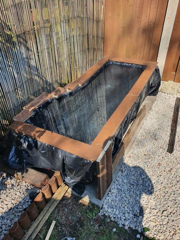 Couple upcycle old bath tub into a garden pond for just £50