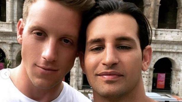 Ollie Locke looks worlds away from his MIC days as he attends Cheltenham with husband 