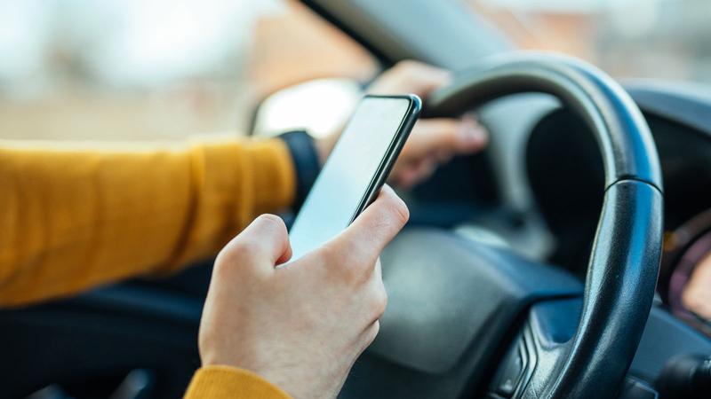 Any use of hand-held mobile phone while driving to become illegal