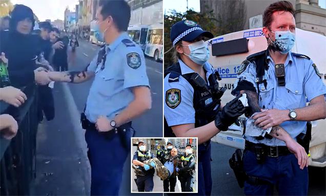 Coronavirus Australia: Officer splattered with ink by protestors later shakes hands with the crowd 