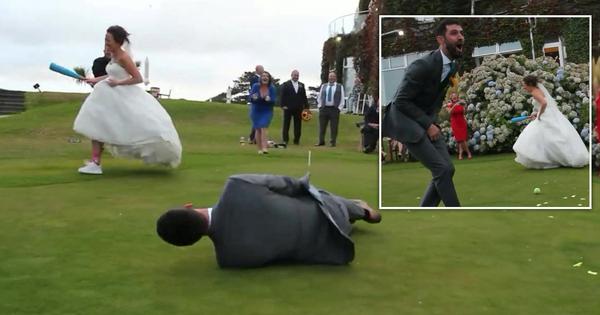 Bride playing a game of rounders at her wedding smacks a ball into her new husband's groin