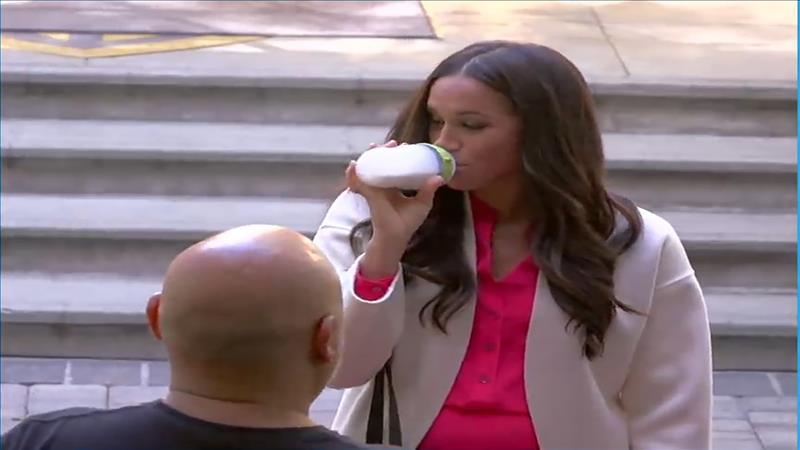 Megan, Prince Harry's wife, drinks milk from a baby bottle on the street. Video